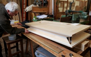 Marek finishing the leather work on the bellows